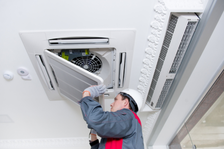 man looking the aircon at the ceiling